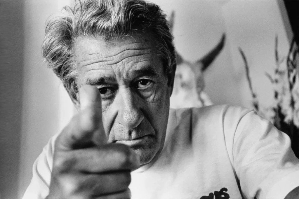 A self-portrait of Helmut Newton pointing at the camera, featured on Variant Journal.