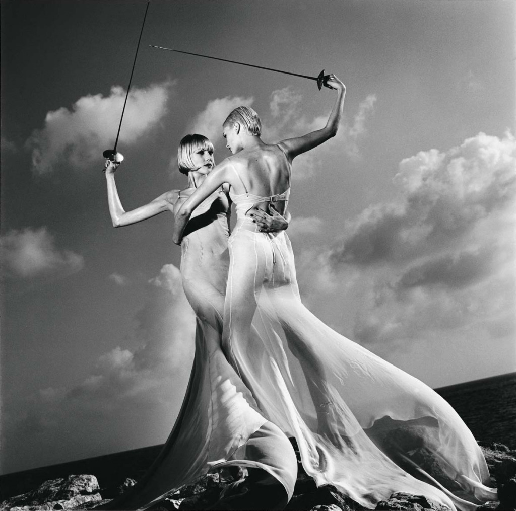 A fashion photograph of two women fencing, by Helmut Newton