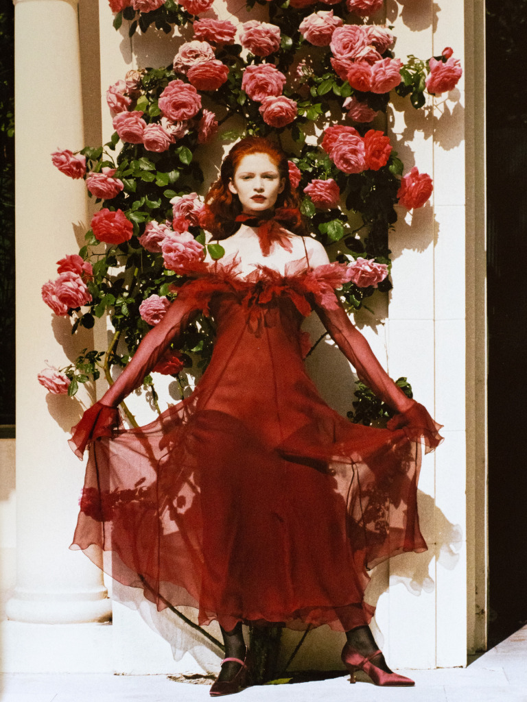 A fashion photograph of a woman and some roses, by Helmut Newton